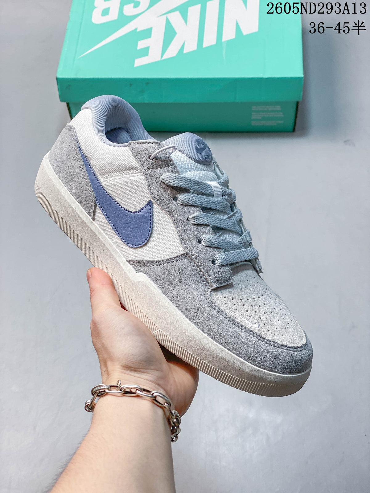 Gray Nike SB Force 58 shoe with a lavender Swoosh and pale blue laces
