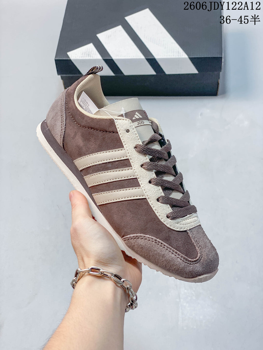 Angled side view of the brown and cream low-top sneaker