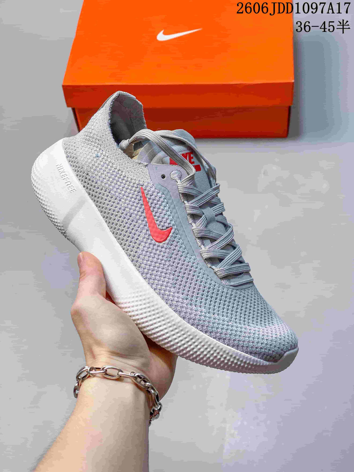 Gray Nike Free 2025 low-top shoe with a coral Swoosh and white sole.