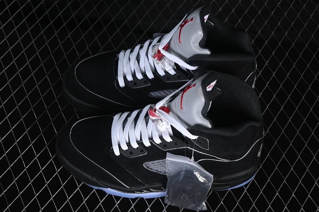 Pair of black high-top sneakers with white laces and gray tongues