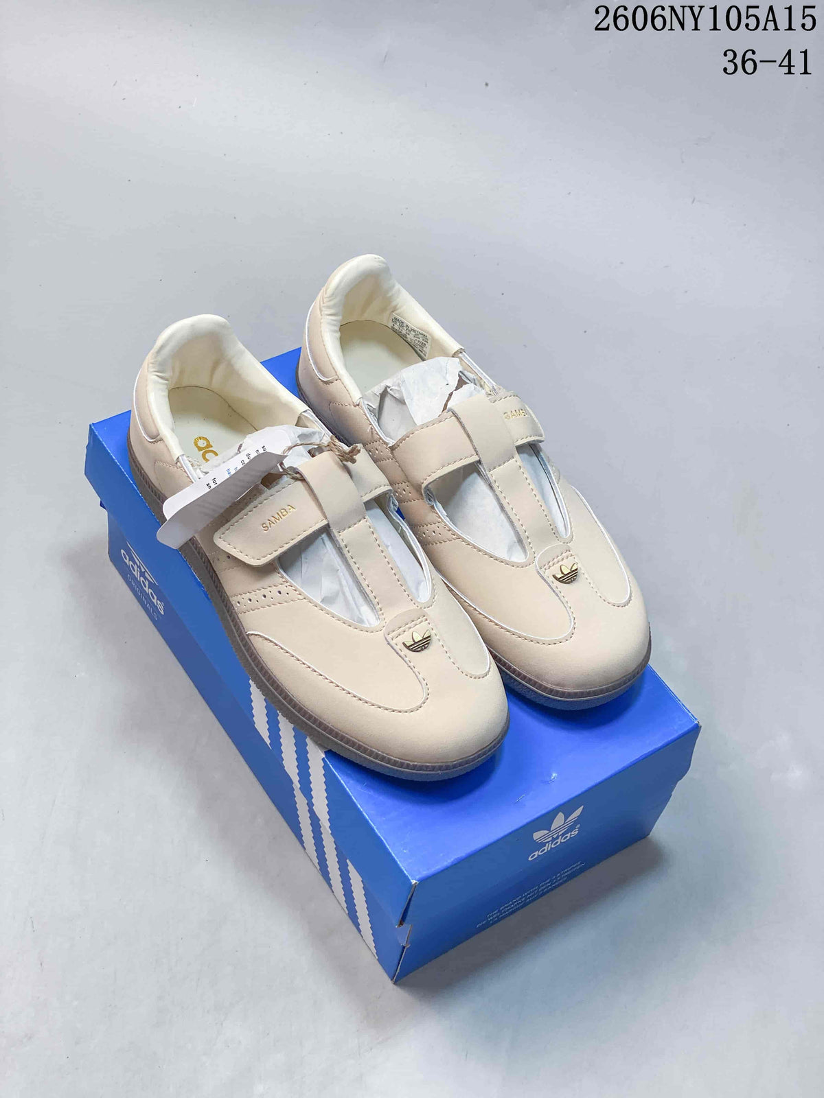 Beige adidas Originals Samba Jane sneakers with hook-and-loop straps, shown on a blue shoebox.