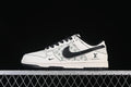 Side view of a cream and black low-top sneaker with a patterned side panel and black laces.