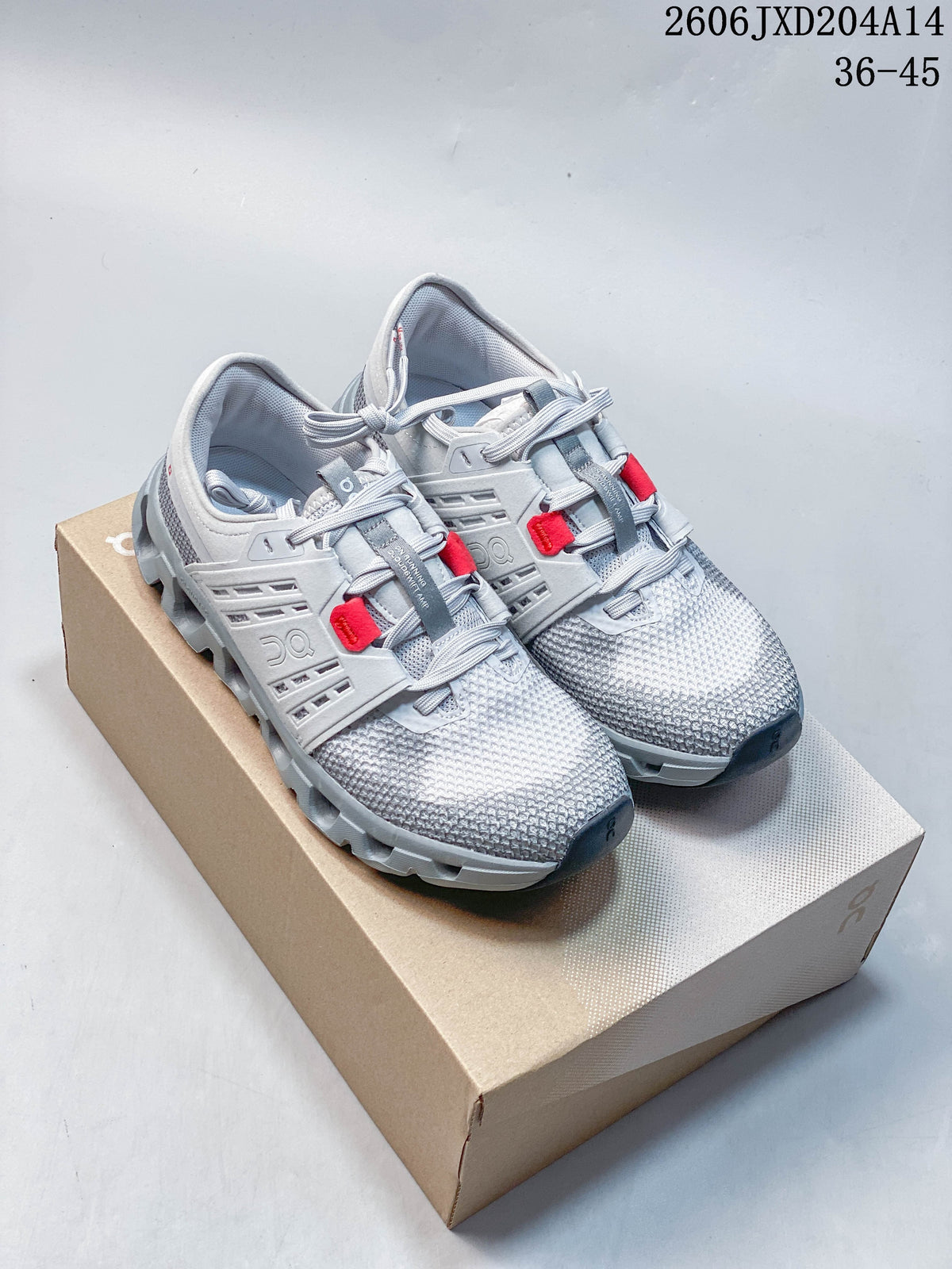 Pair of light gray running shoes with red lace accents