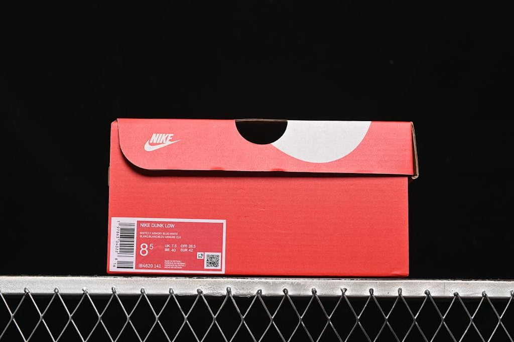 Red shoe box with a label identifying Nike Dunk Low and EU 42
