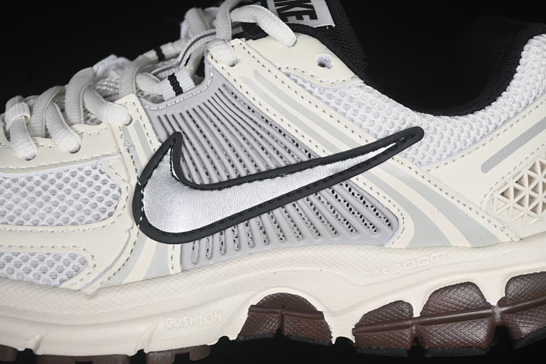 Close-up of the silver Swoosh, grey side panel, mesh upper and midsole markings.