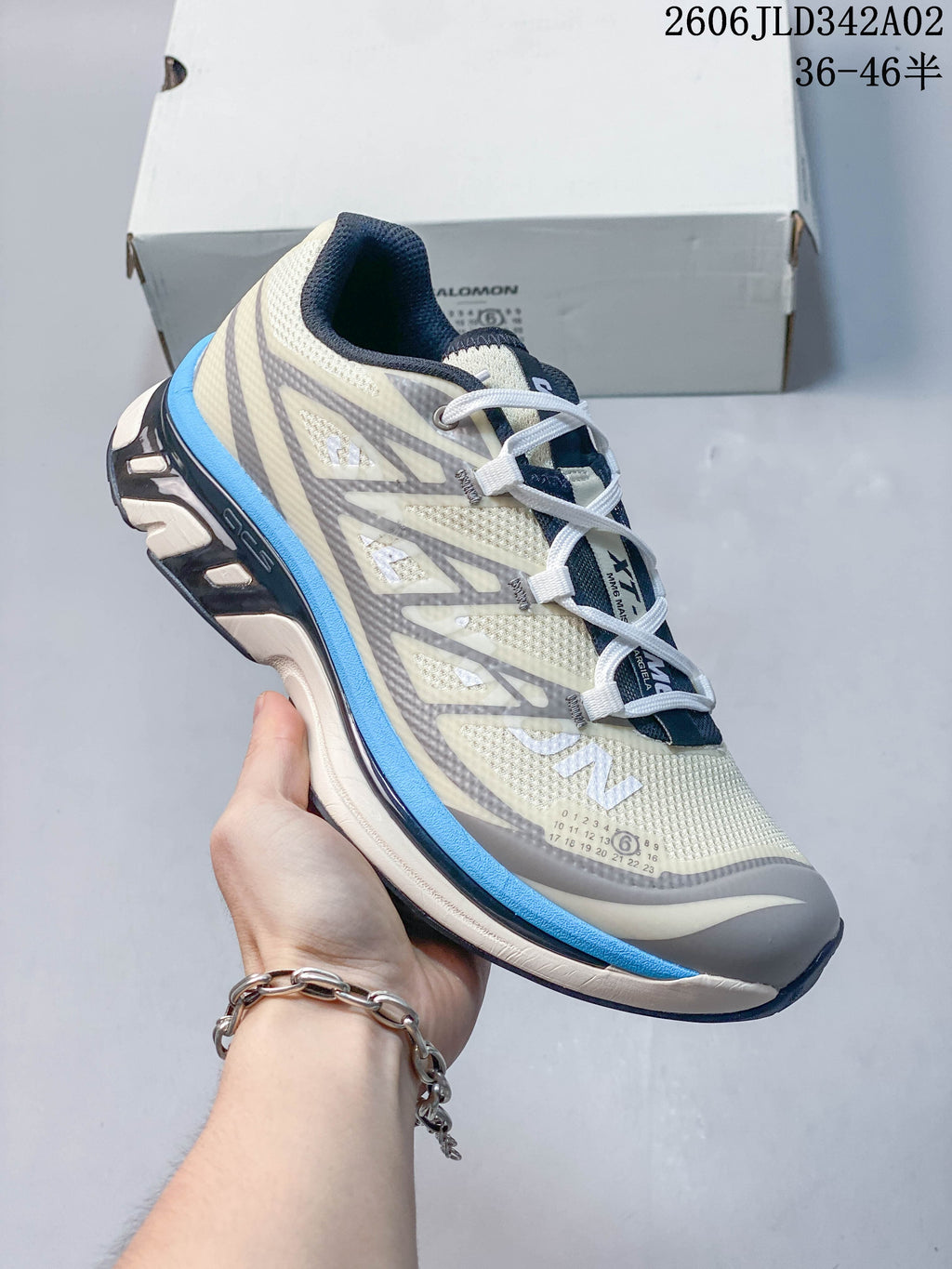 Angled side view of the Salomon shoe with gray overlays and blue midsole accent