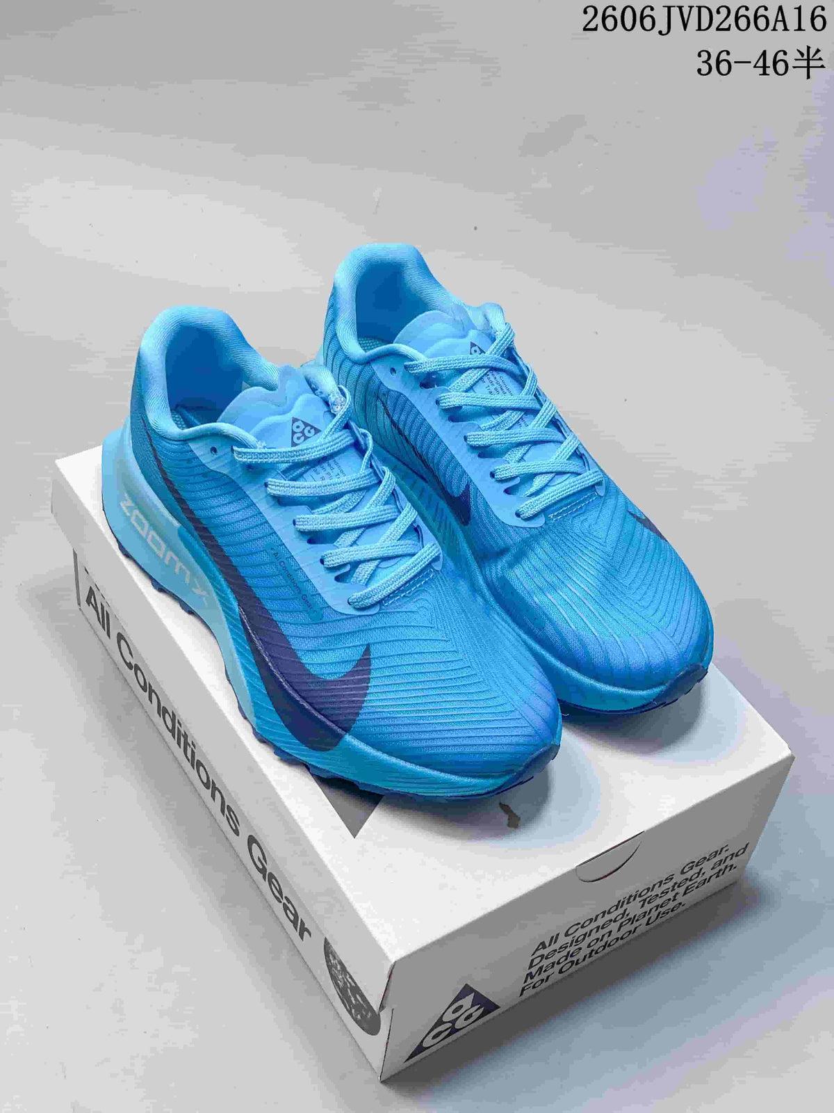 Blue Nike ACG trail shoes displayed on an ACG box
