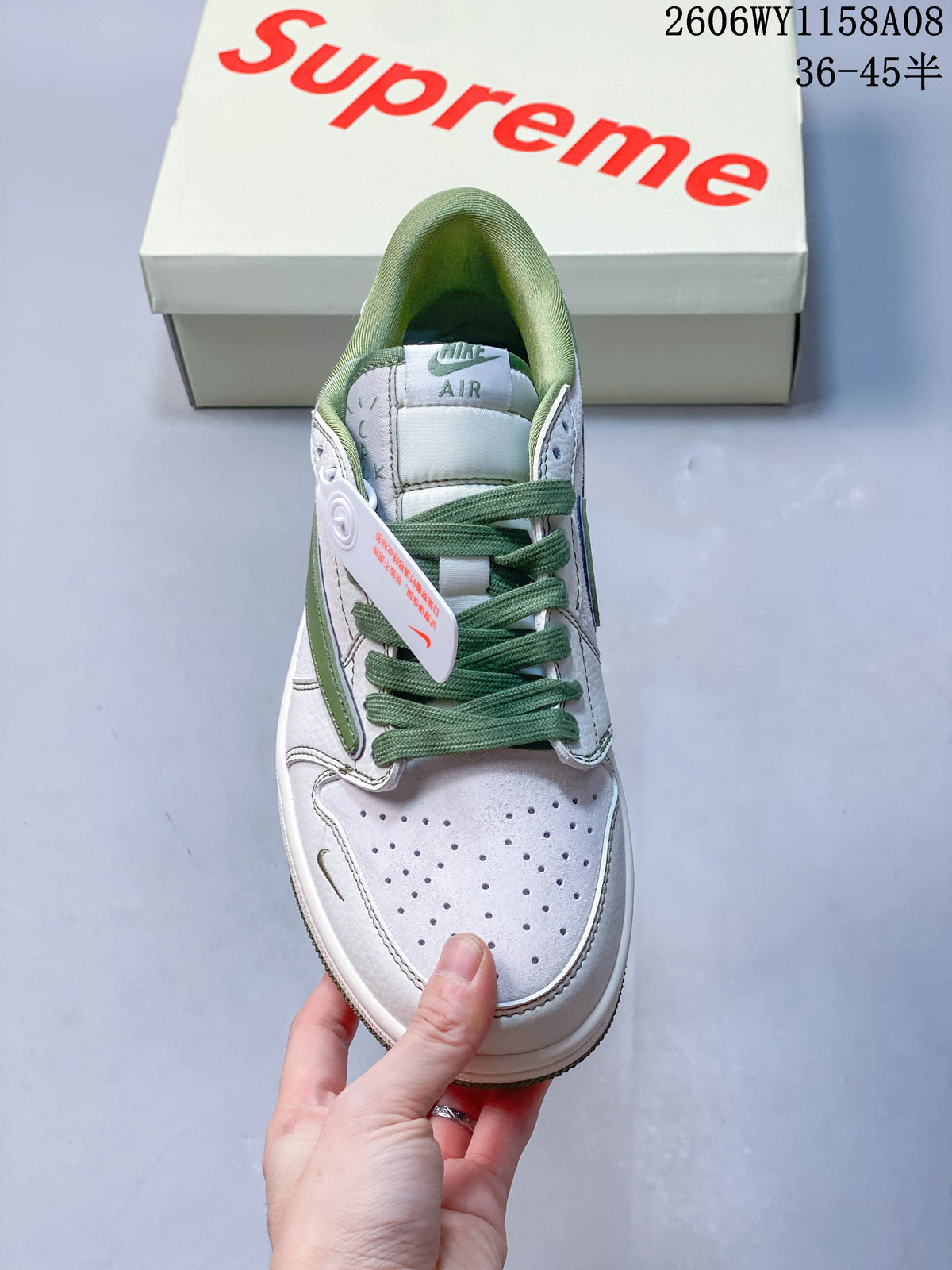 Front view showing perforated toe, green laces, and green collar lining