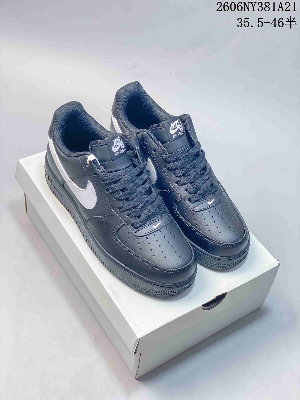 Dark sneakers with white Swooshes, shown from above