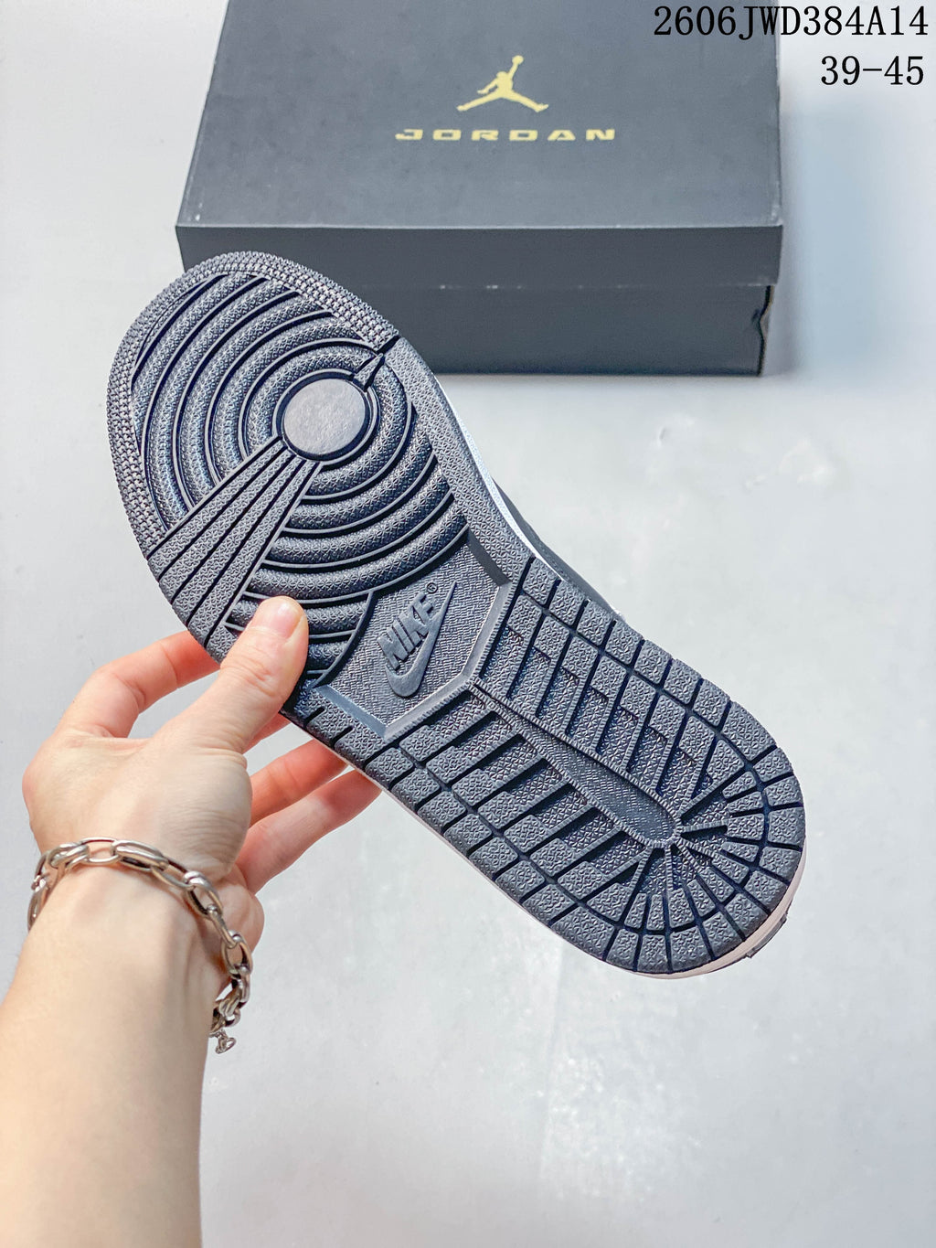 Close-up of the patterned outsole on a dark grey Jordan sneaker