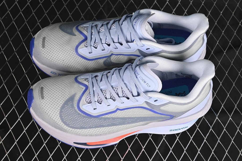 Pair of gray and blue Nike Zoom Fly 6 shoes viewed from above.