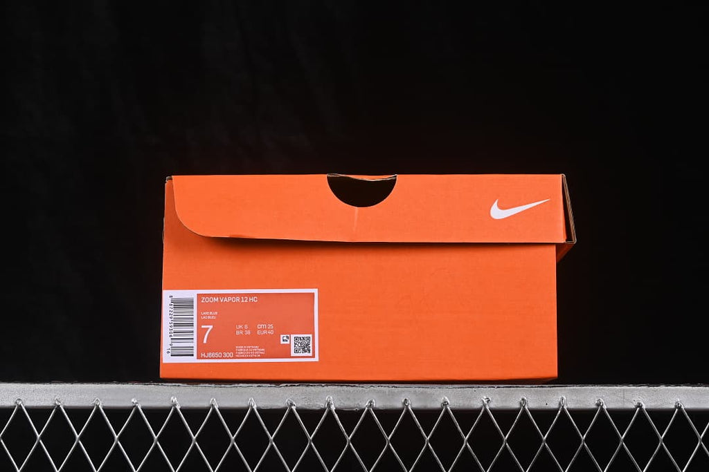 Orange Nike shoebox labeled Zoom Vapor 12 HC with size 7 and style code HJ6650-300.