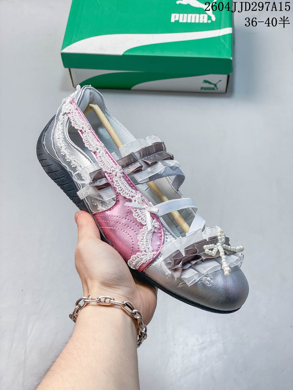 Side view of a silver and pink embellished low-profile sneaker