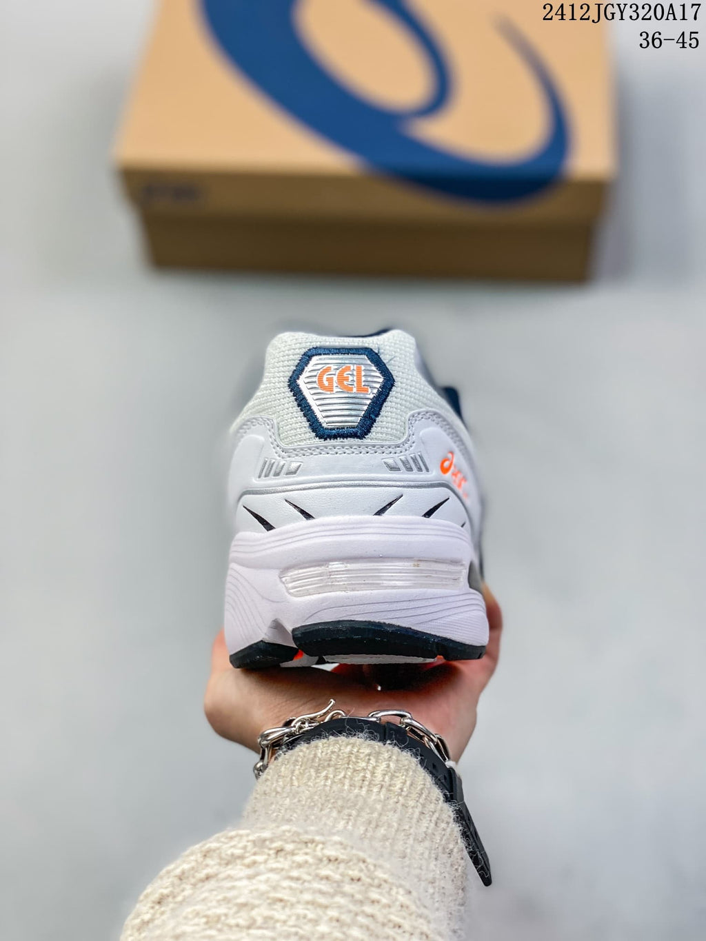 Rear view of the white ASICS GEL-1090 sneaker with visible heel cushioning detail