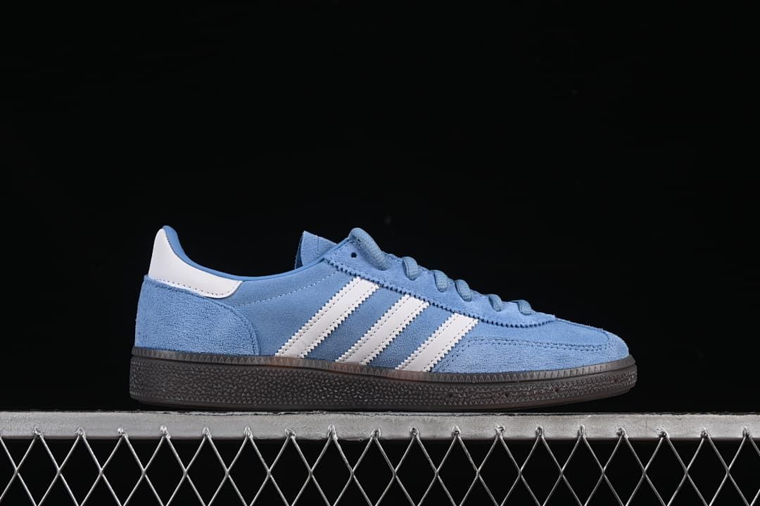 Side profile showing the blue upper, white stripes and dark sole