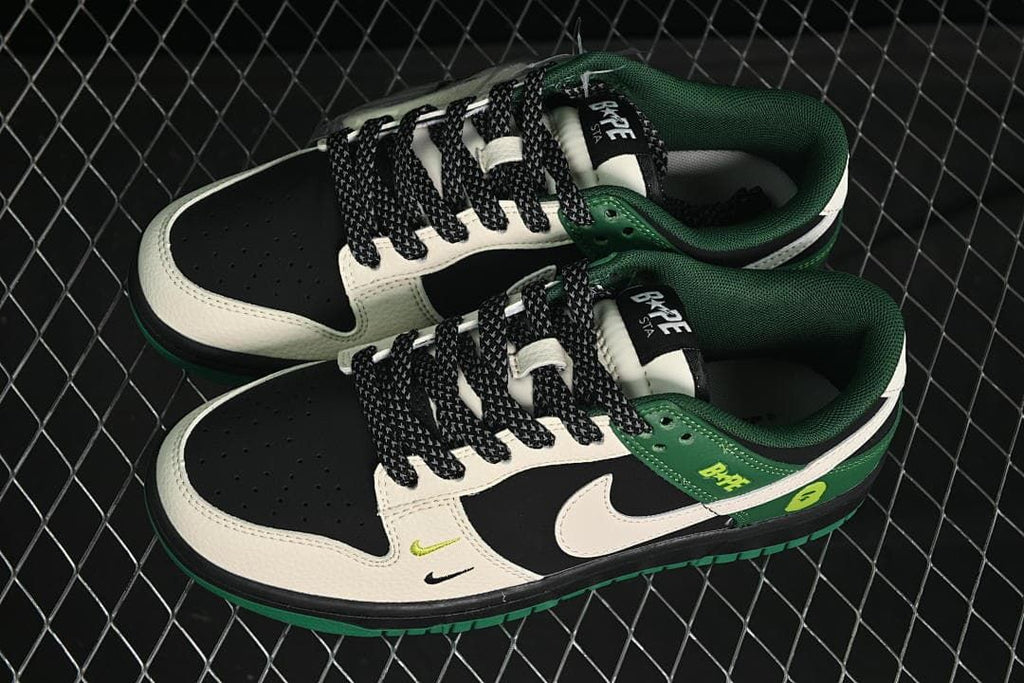 Overhead view of a pair of black, cream and green low-top sneakers with patterned laces