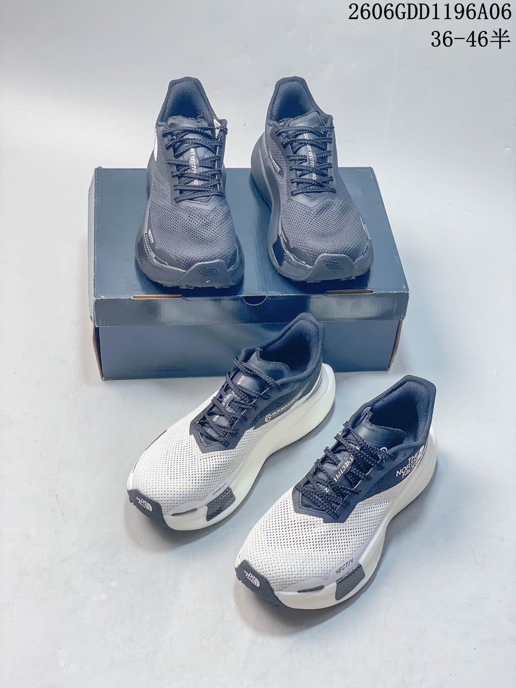 Gray and white The North Face sneakers shown together from front and angled views.