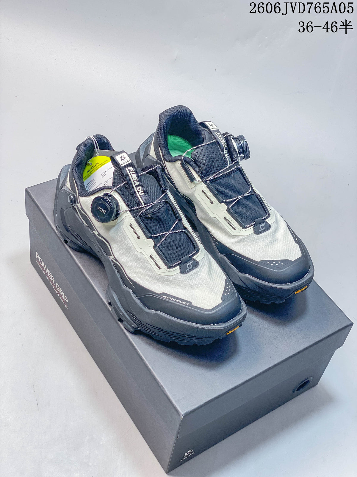 Pair of light gray and navy Kailas FUGA BOA trail shoes shown from above on a shoe box.
