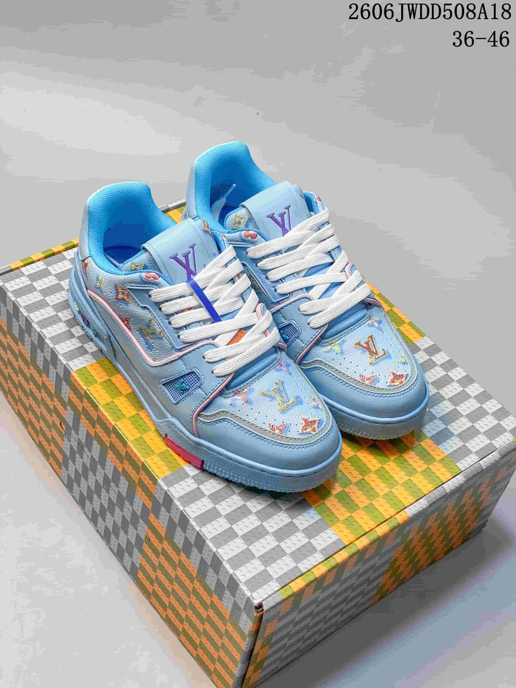 Pair of light blue patterned low-top sneakers with white laces and pink accents