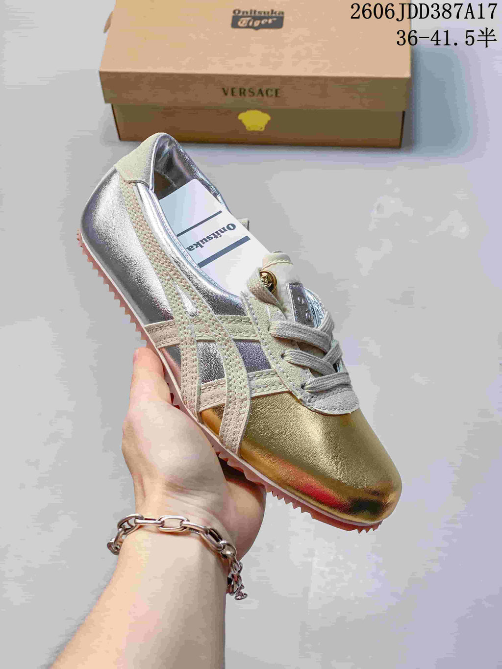 Angled view of the sneaker's gold-tone toe, silver panels, and light overlays