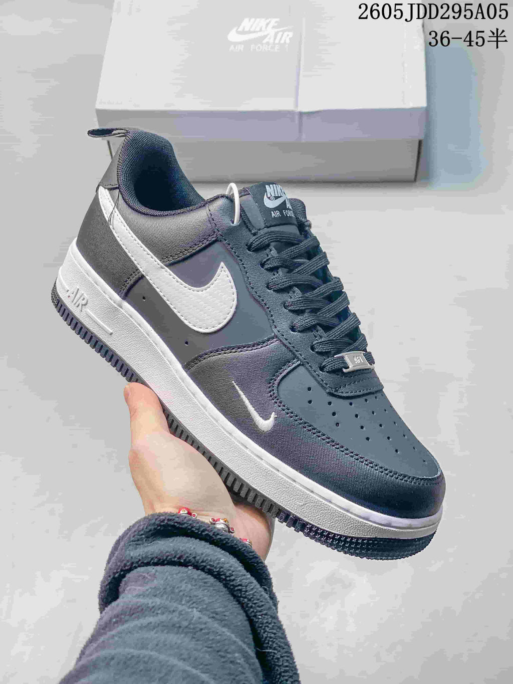 Dark gray Nike Air Force 1 low-top sneaker with white Swoosh and white midsole