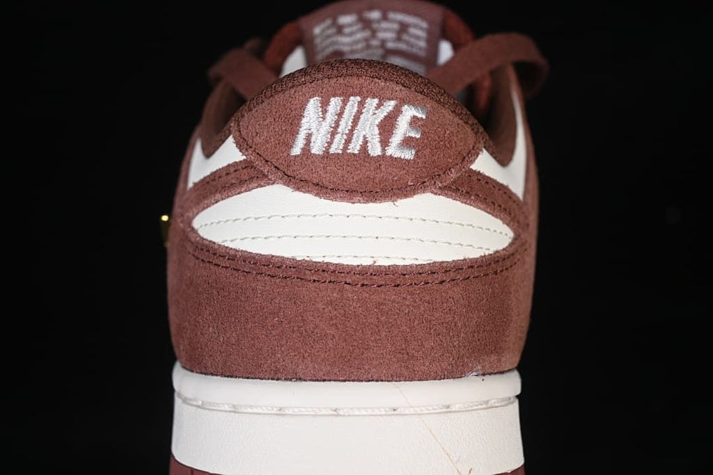 Rear view showing brown heel panels, white accents, and embroidered Nike branding