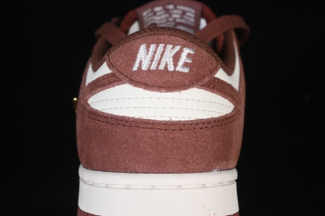 Rear view showing brown heel panels, white accents, and embroidered Nike branding