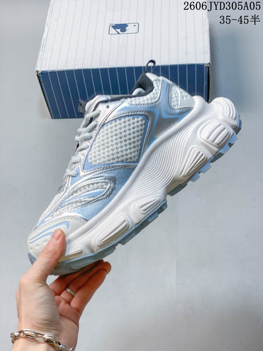 Side view highlighting layered panels and the chunky sculpted sole.
