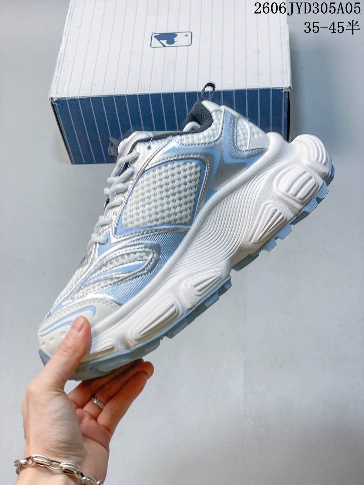 Side view highlighting layered panels and the chunky sculpted sole.