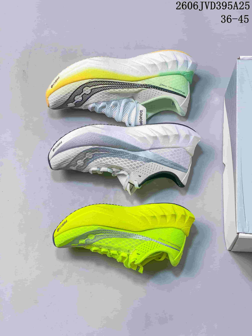 Side views of three Saucony Endorphin Speed 5 colorways: white with green accents, white with blue-gray accents, and neon yellow.