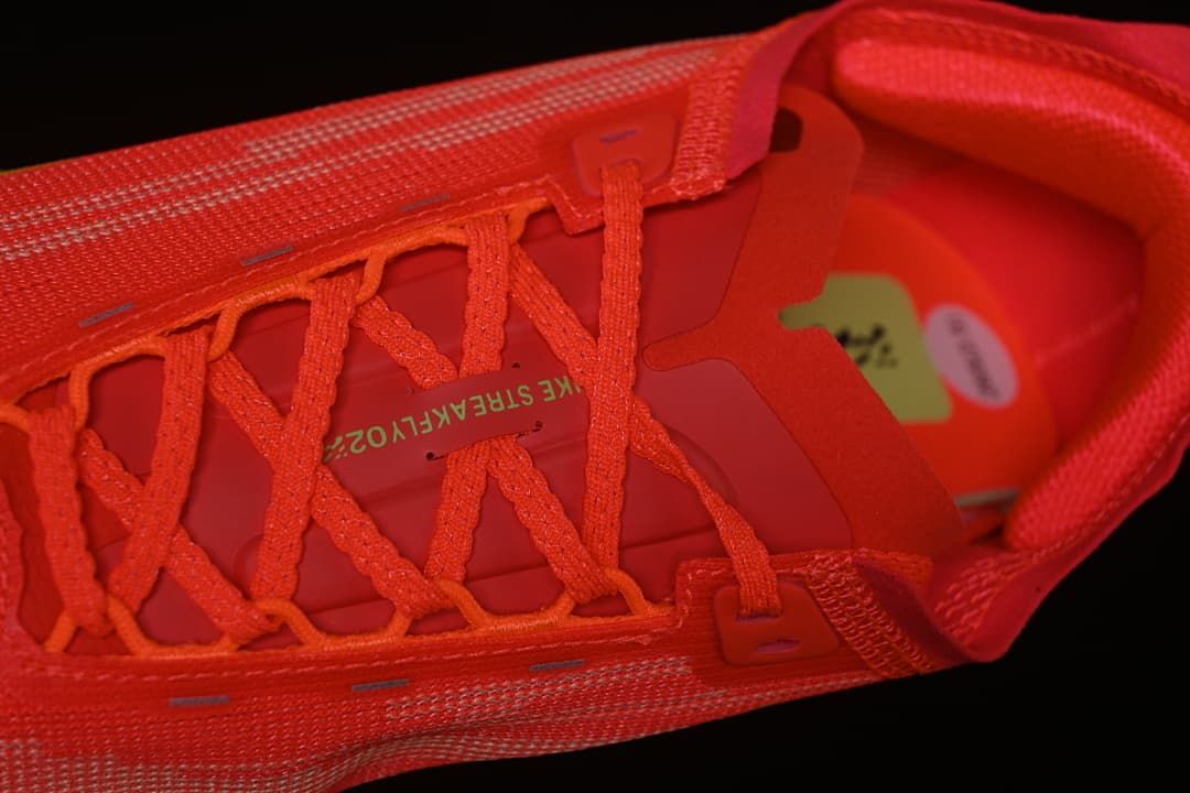 Close-up of the coral-red laces and tongue.