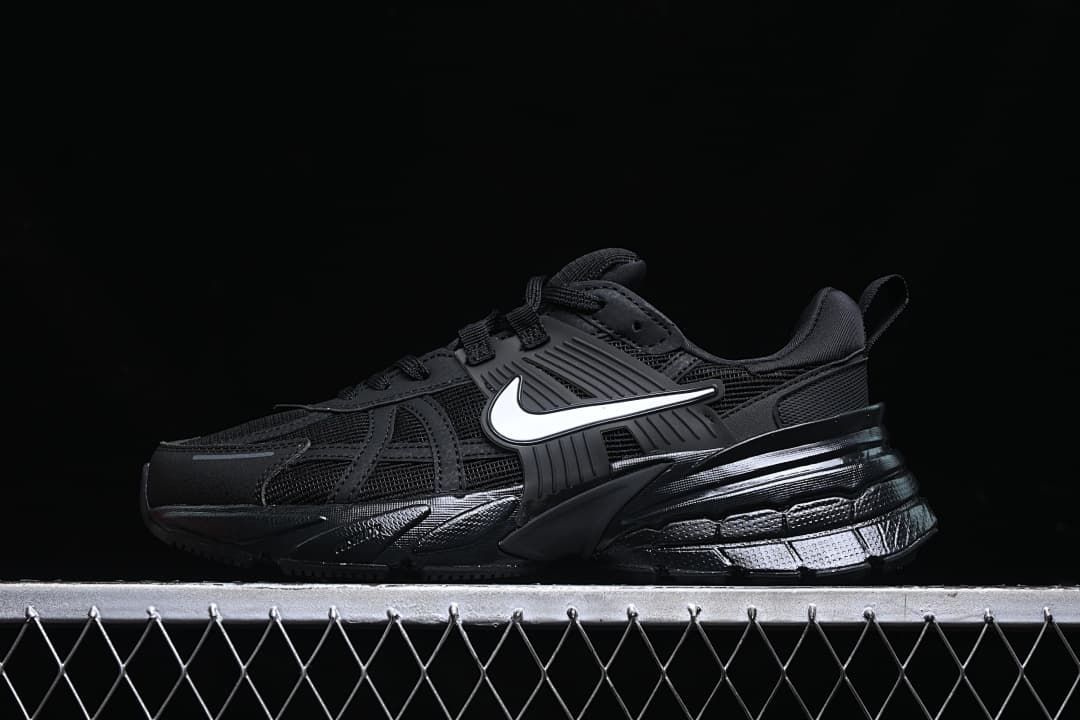 Side view of black Nike V2K Run shoes with a white Swoosh