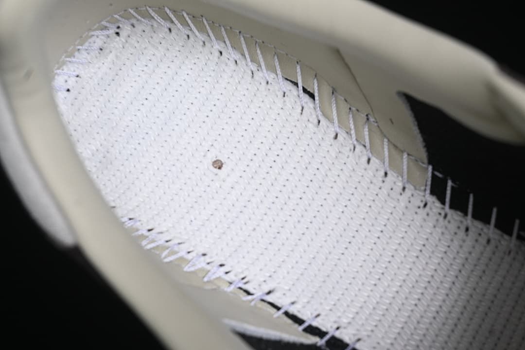 Close-up of the sneaker's light perforated interior and stitching