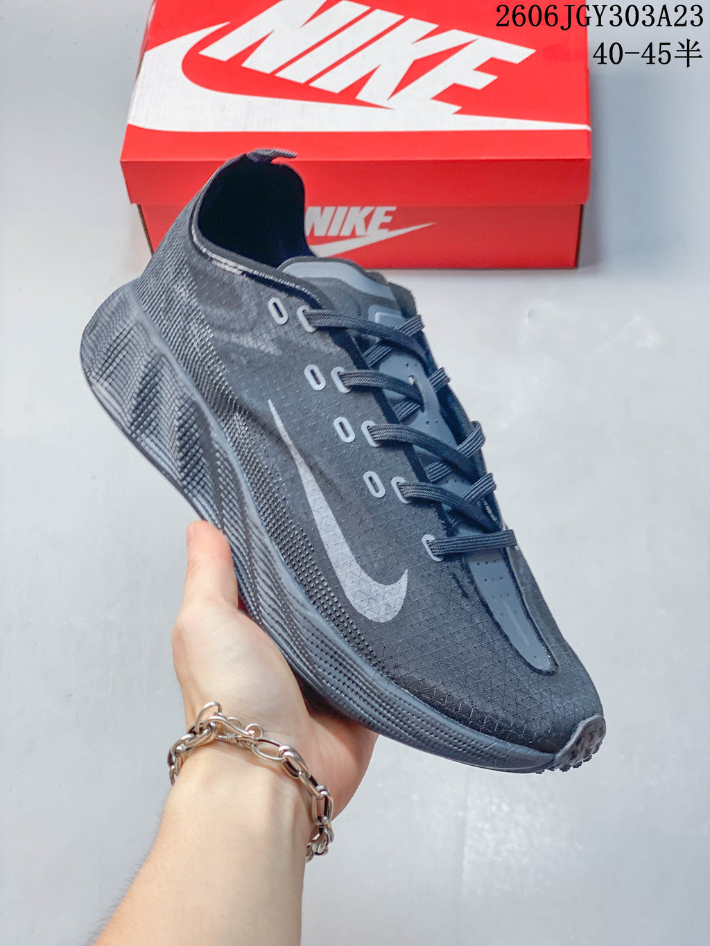 Side view of a charcoal gray Nike Ava Rover shoe with a lace-up front and textured outsole.