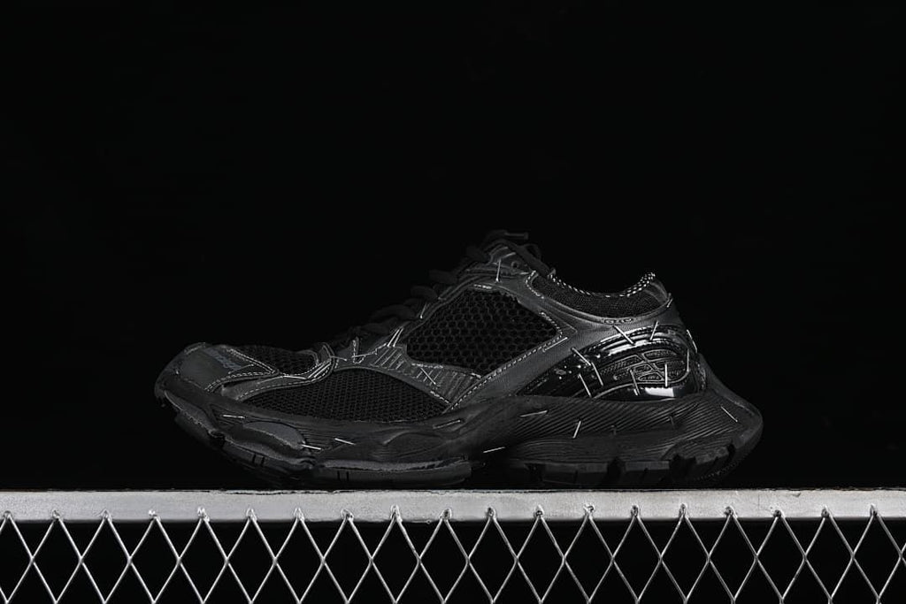 Black Balenciaga Stapler sneaker shown in side profile against a dark background.