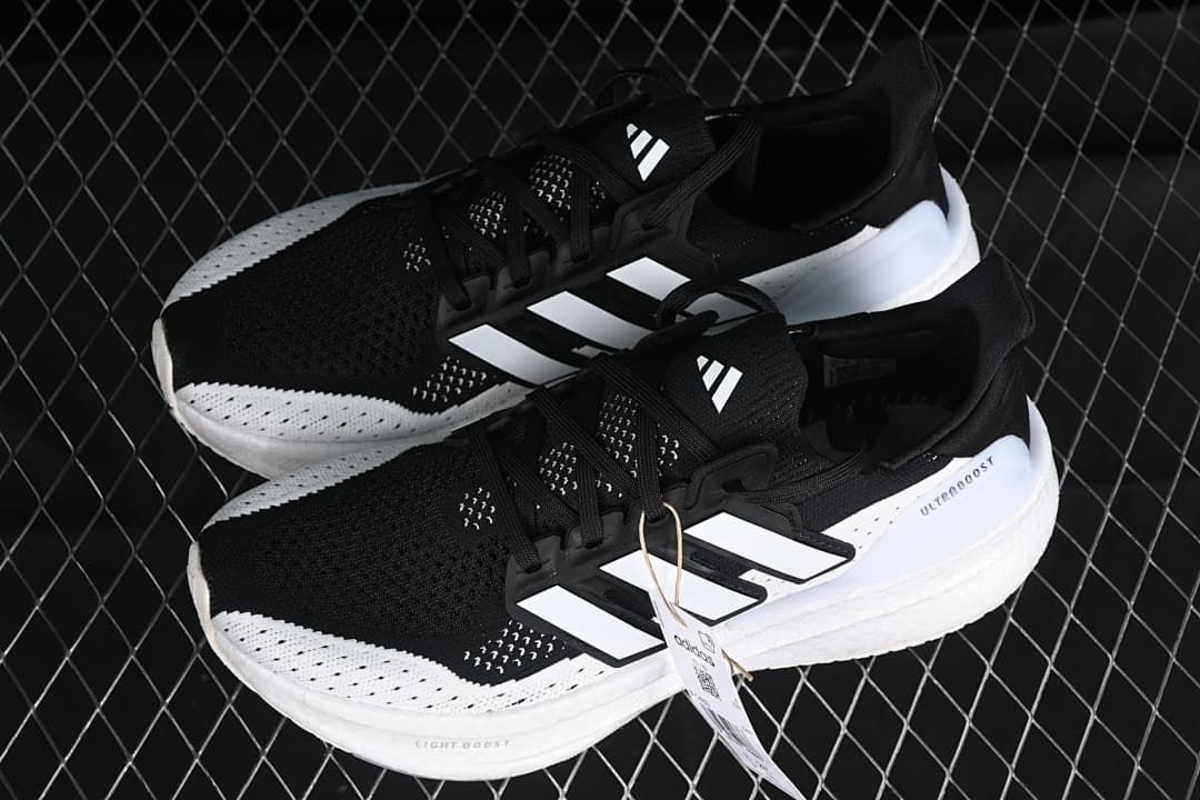 Pair of black and white Adidas Ultraboost 5 shoes
