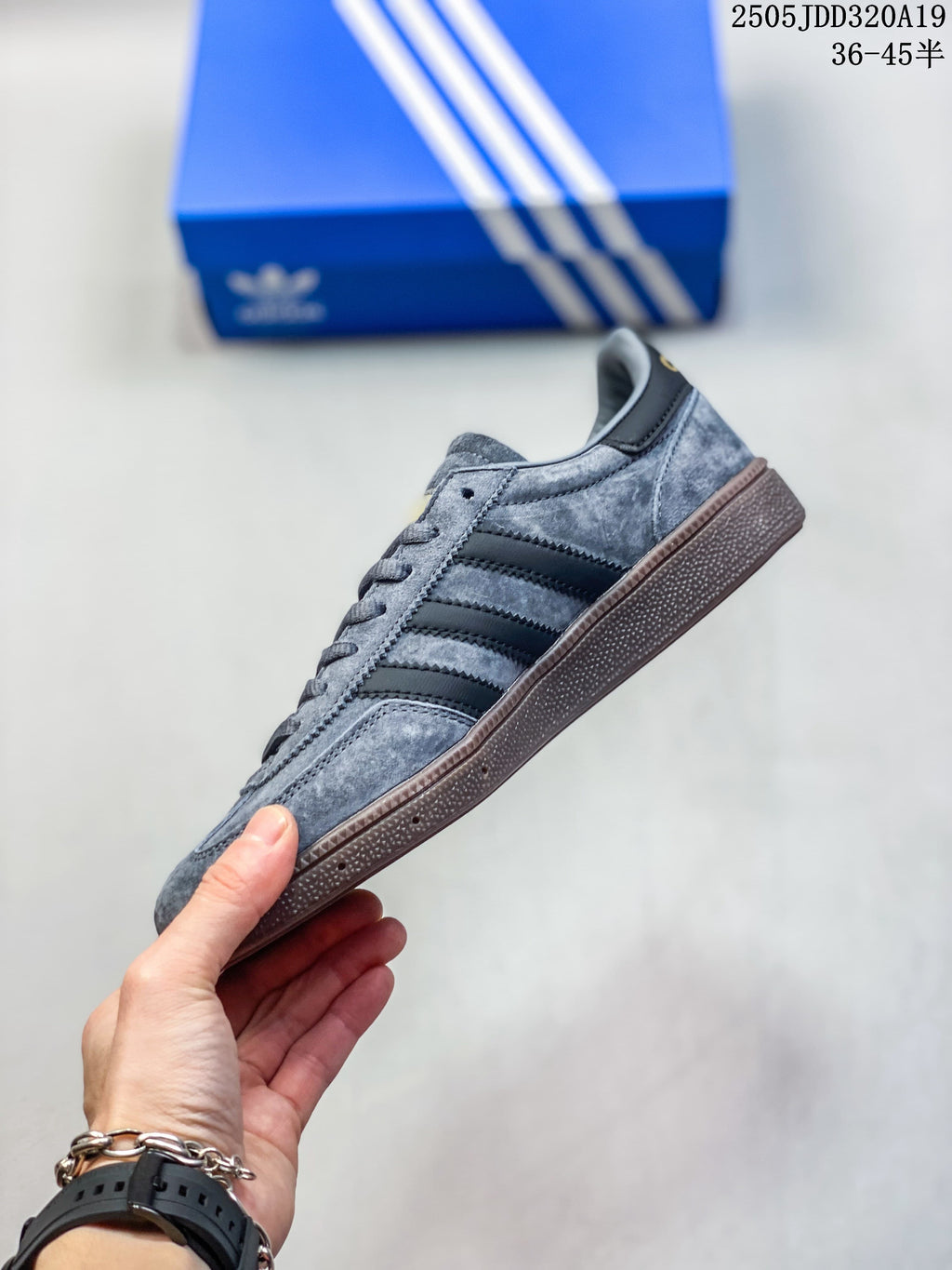 Side profile of a grey low-top sneaker with black stripes and a brown gum-look sole.