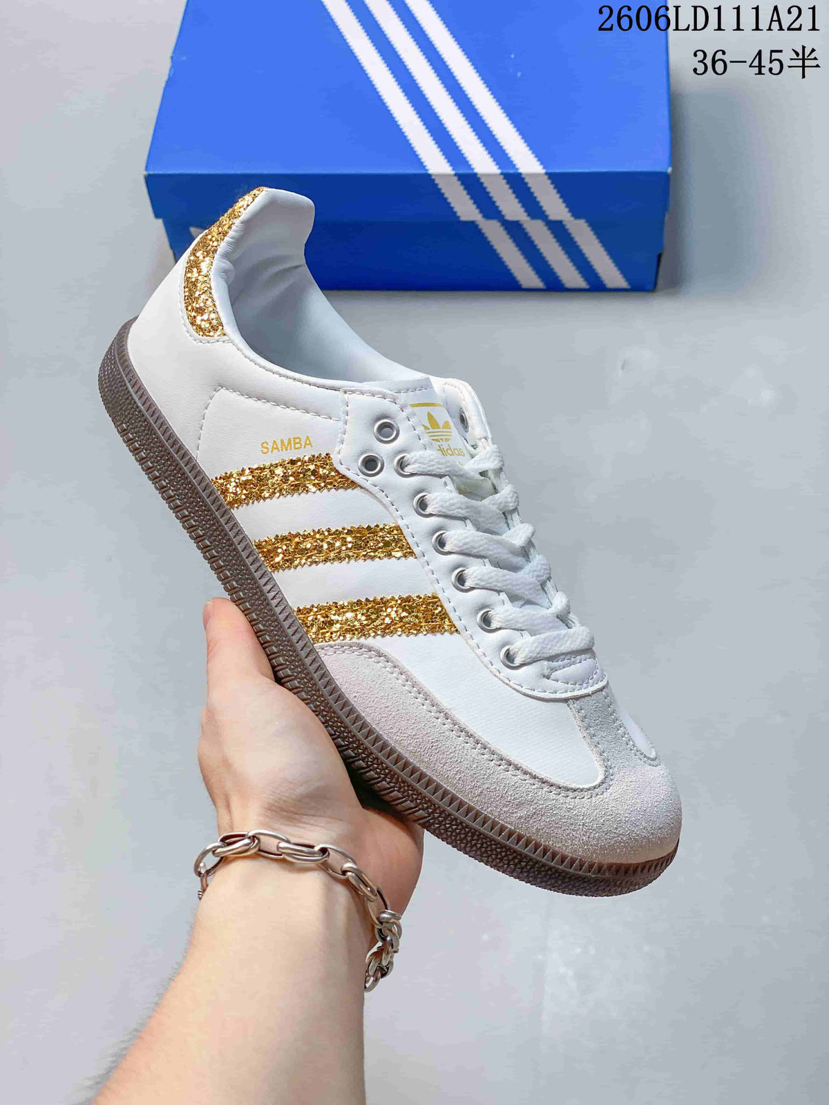 Side view of a white low-top sneaker with gold glitter stripes and a gum-colored outsole