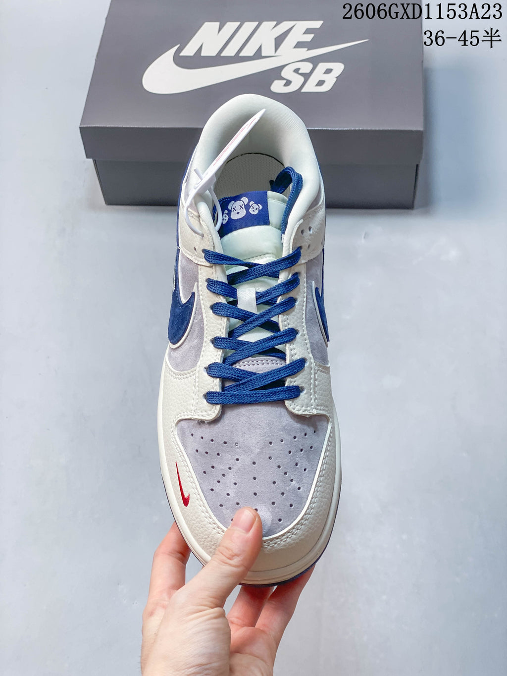Top view highlighting blue laces, perforated toe panel, and tongue graphics.