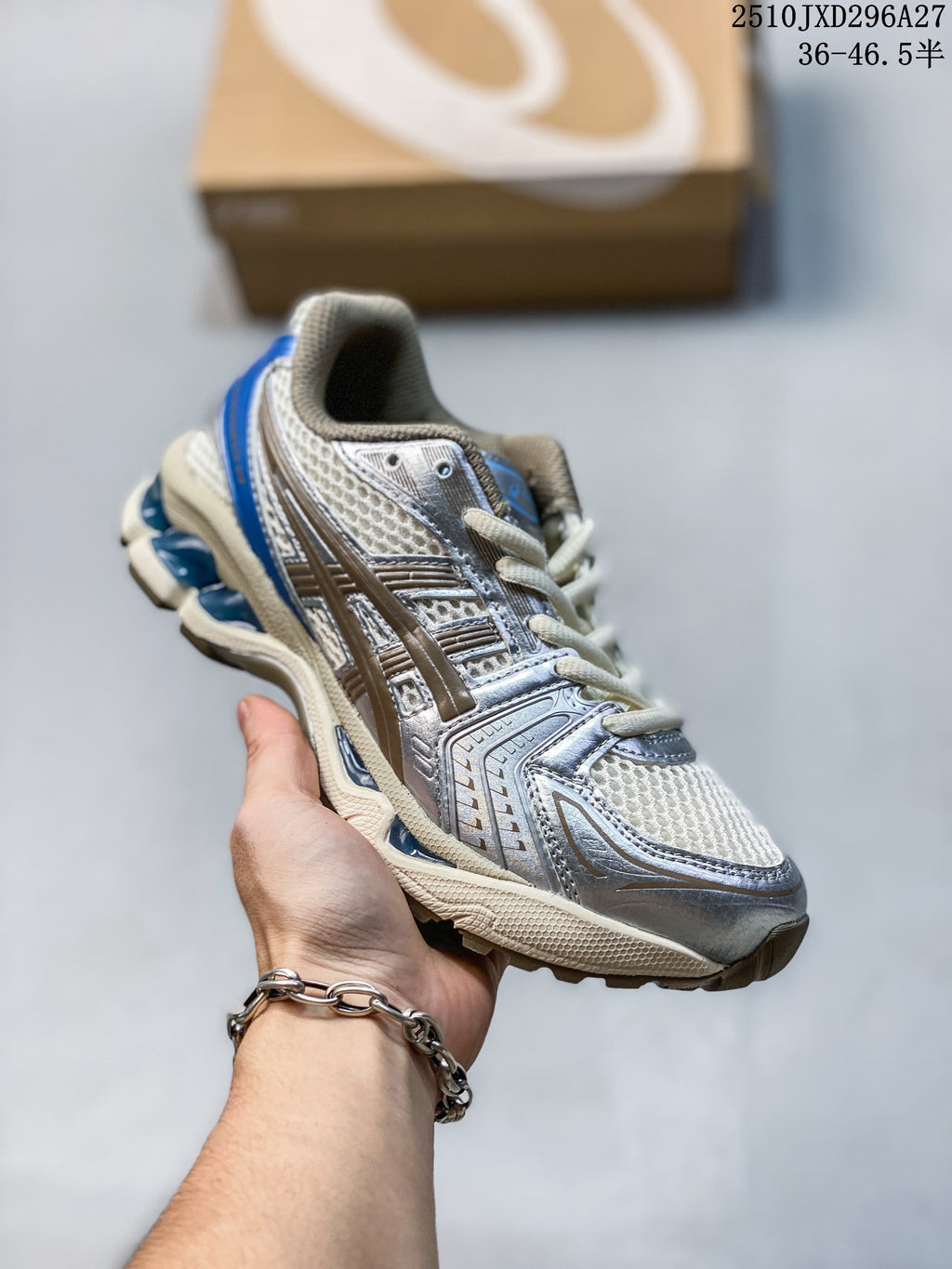 Silver mesh sneaker with bronze and blue details and cream-colored sole accents, held in hand.