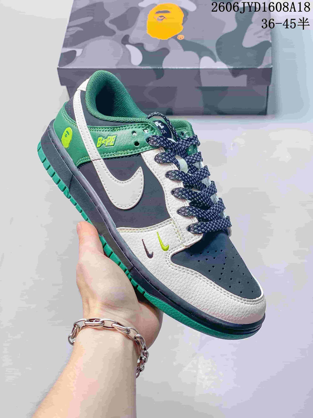 Angled side view showing the sneaker's color-blocked panels and green outsole