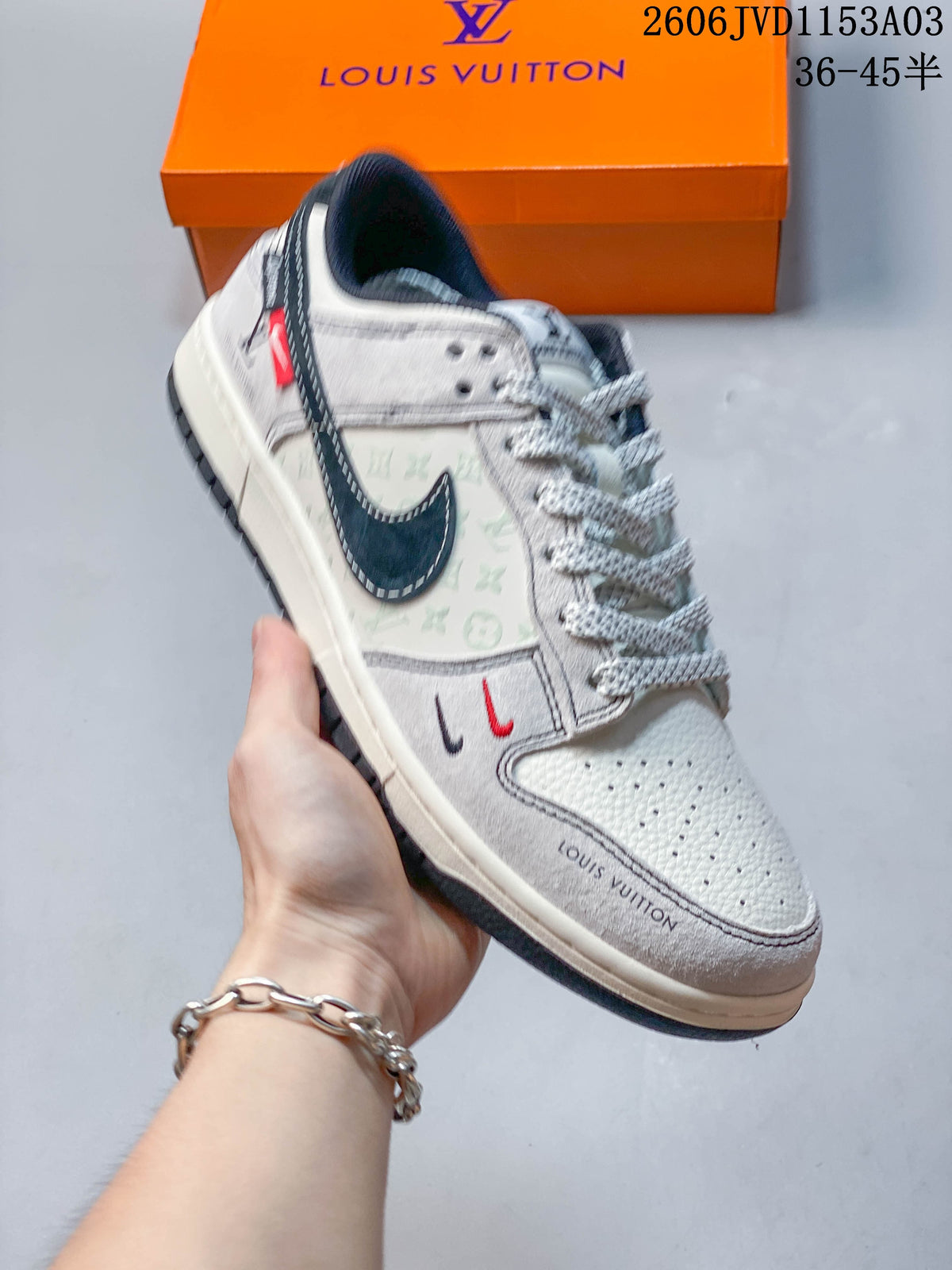 Light gray low-top sneaker with layered swoosh-shaped side panel and patterned detailing