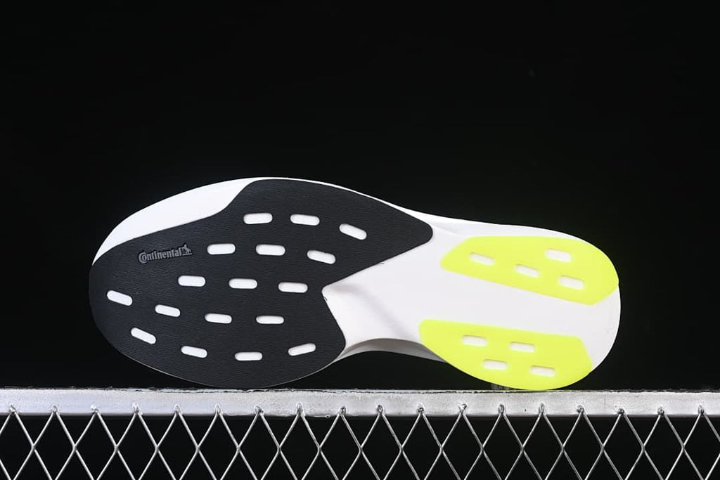 Outsole view with black, white, and lime sections and visible Continental branding.