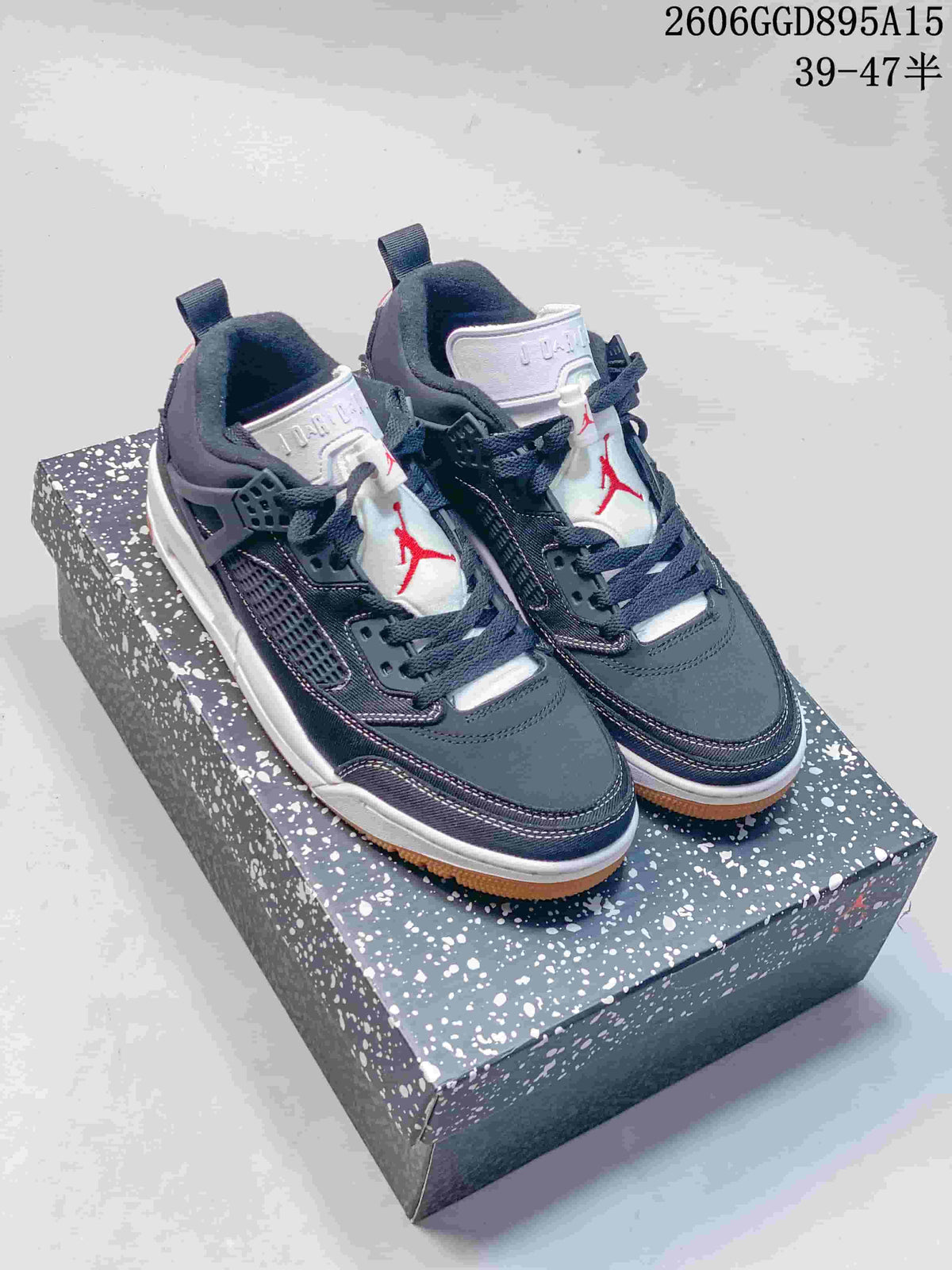 Dark navy Jordan Spizike Low sneakers displayed on a speckled box