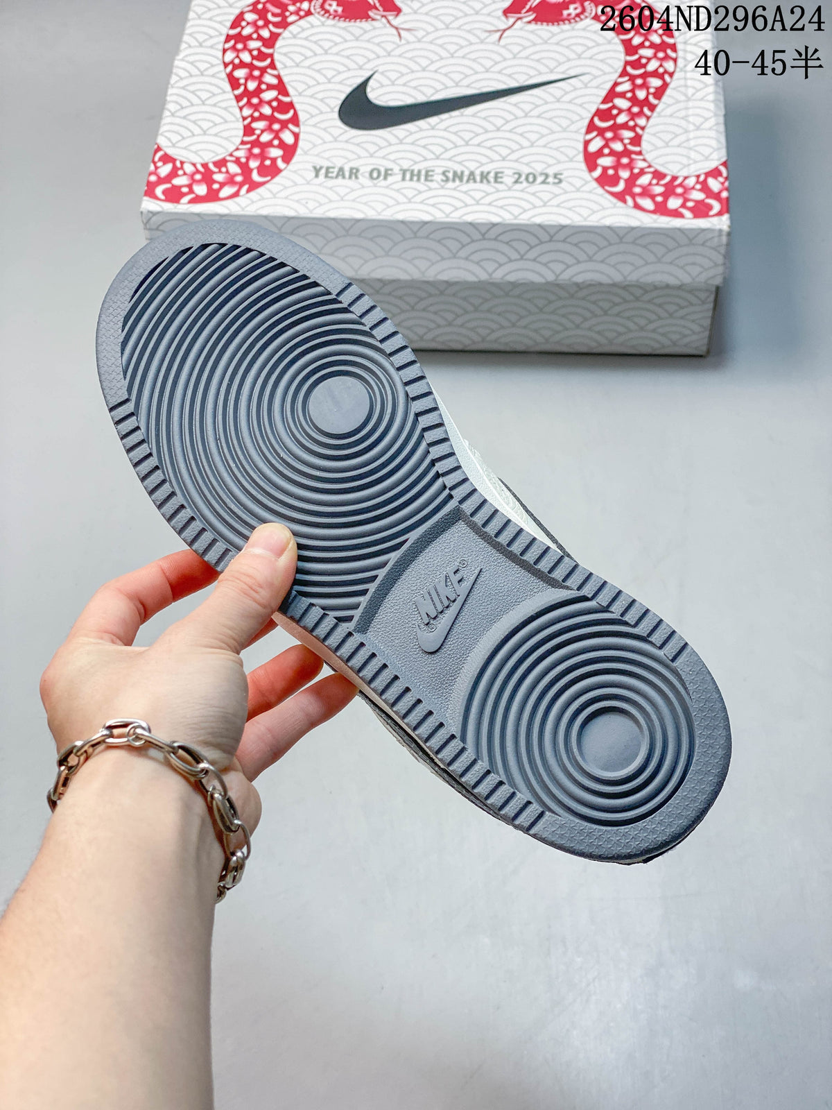 Underside of the sneaker showing a circular-pattern slate-blue outsole and Year of the Snake 2025 box