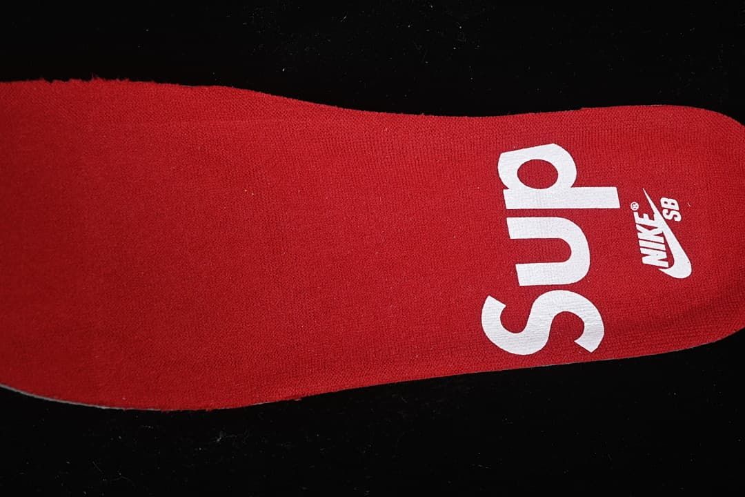 Close-up of a red insole printed with Supreme and Nike SB branding