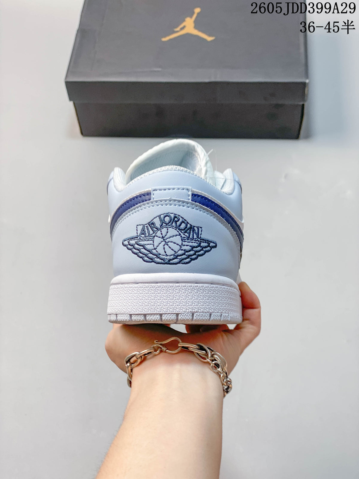 Rear view showing the embroidered Jordan Wings logo on a light blue heel