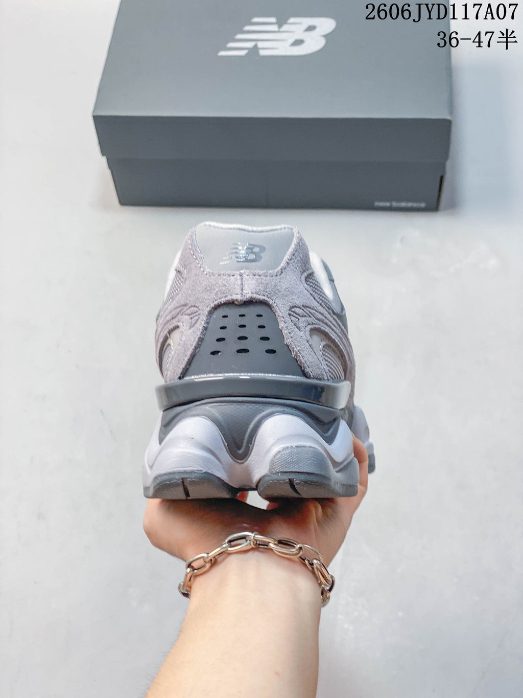 Rear view of a grey New Balance 9060 sneaker with a sculpted heel and sole