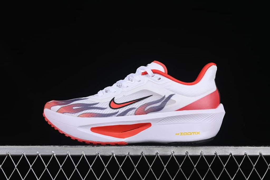 Side view of white Nike Zoom Fly 6 running shoe with red accents and flame-inspired graphics
