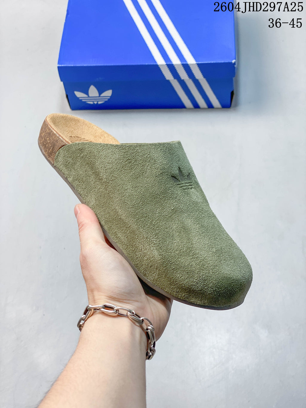 Close-up of an olive green Adidas Adimule mule showing its broad upper and cork-colored footbed
